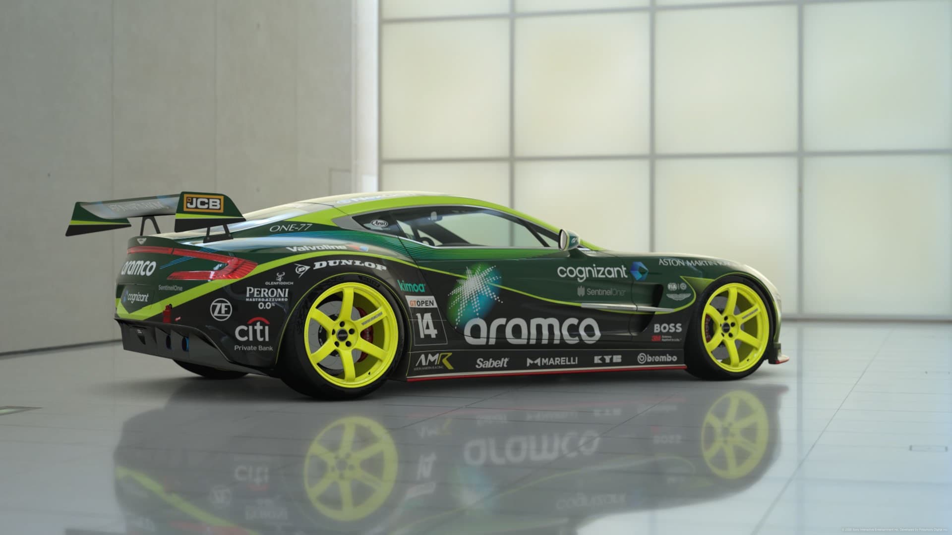 Green GT race car displayed in a studio